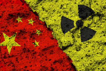 Concept of the Nuclear Energy Policy of the Peoples Republic of China with a flag and a radiation hazard sign painted on a rough wall