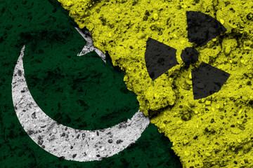 Concept of the Nuclear Energy Policy of Pakistan with a flag and a radiation hazard sign painted on...