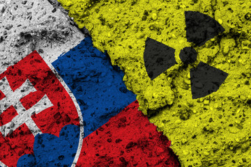 Concept of the Nuclear Energy Policy of Slovakia with a flag and a radiation hazard sign painted on a rough wall