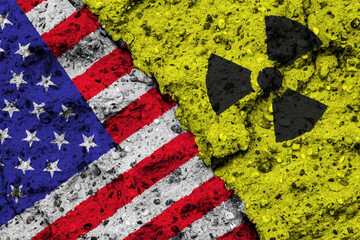 Concept of the Nuclear Energy Policy of the United States of America (USA) with a flag and a radiation hazard sign painted on a rough wall