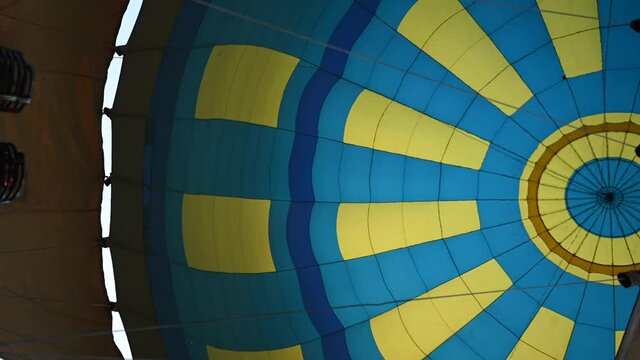 Hot air balloons open festival, balloons of different colours fly over rocky mountains, balloons flying on sunset over cloudy sky, 4k HDR cinematic footage