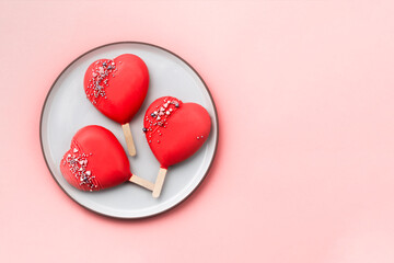 Red cakepops, popsicles on white plate. Red hearts. Love and sweet concept. Valentine day. White background.