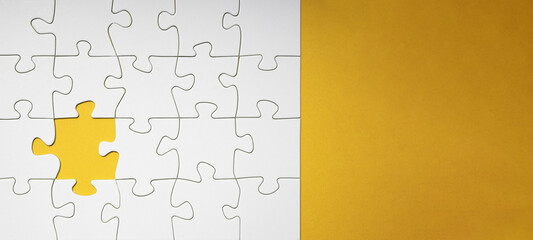 Empty white details of puzzle on yellow background banner panorama, with space for text