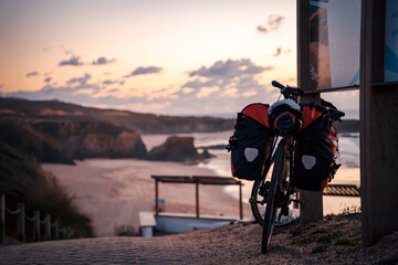 Bicycle with bags by the Almograve beach, Alentejo, Portugal