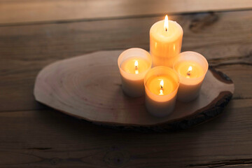 Warm candles on a wooden table. Autumnal decoration