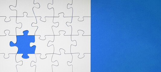 Empty white details of puzzle on blue background banner panorama, with space for text