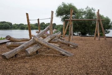 children's playground made of environment, eco-friendly materials. Wooden tree trunk sides, swings,...