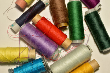 Spools of colored thread are on the table.