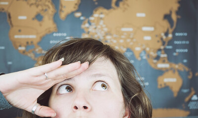 Wanderlust concept image of a woman near a world map