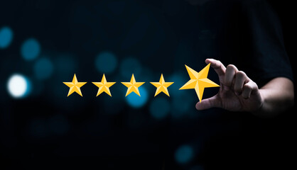 Businessman holding and input  yellow star to five stars for customer satisfaction after use...