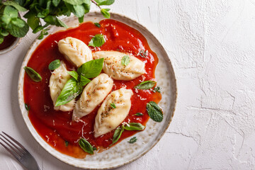 traditional Italian food culurgiones with tomato sauce and basil - obrazy, fototapety, plakaty