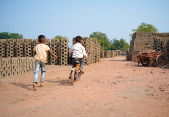 Indian labor's little child playing at brick factory.