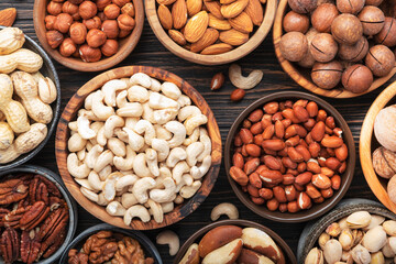 Nuts in assortment, Walnuts, pecans, almonds and other. Healthy food snack mix on wooden table background, top view