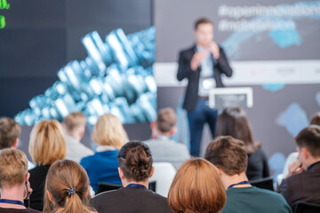 Audience watching presentation during business seminar