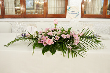 Some flowers on a table prepared for the wedding