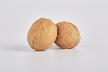 Two walnuts on a light background close-up