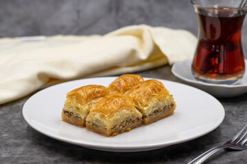 Walnut baklava on a dark background. Traditional Turkish cuisine delicacies. Close-up.
