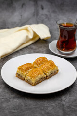 Walnut baklava on a dark background. Traditional Turkish cuisine delicacies. Close-up.