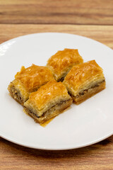 Walnut baklava on a wooden background. Traditional Turkish cuisine delicacies. Close-up.