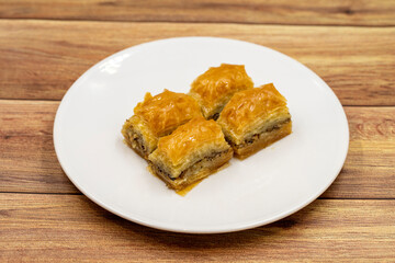 Walnut baklava on a wooden background. Traditional Turkish cuisine delicacies. Close-up.