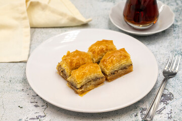 Walnut baklava on a stone background. Traditional Turkish cuisine delicacies. Close-up.