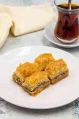 Walnut baklava on a stone background. Traditional Turkish cuisine delicacies. Close-up.