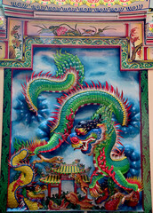 Closeup of Tha Colorful Dragon Decoration On the black wall background at Thai Temple at Thailand.