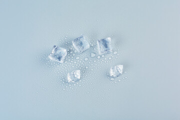 Five ice cubes on a gray background in the center