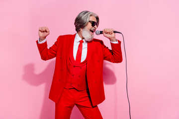 Portrait of attractive trendy talented grey-haired man mc singing hit festal night isolated over...