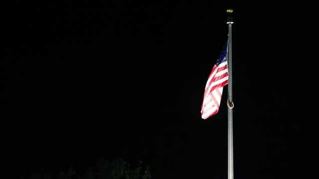 American flag at night against dark sky