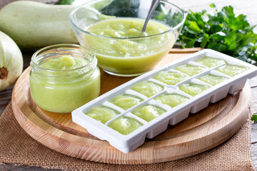 Vegetable puree in ice cubes tray ready to be frozen on a table. Frozen Food Concept.