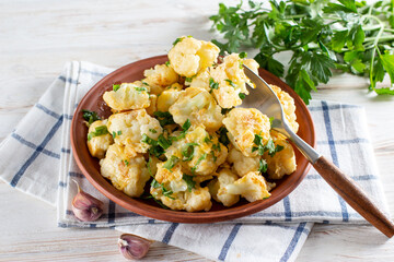 Fried cauliflower with egg and cheese with herbs