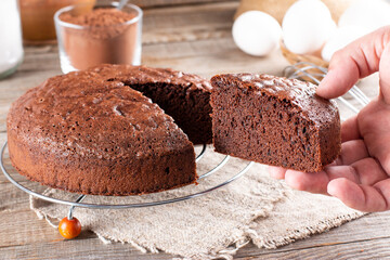Piece of delicious fresh homemade chocolate sponge cake on table