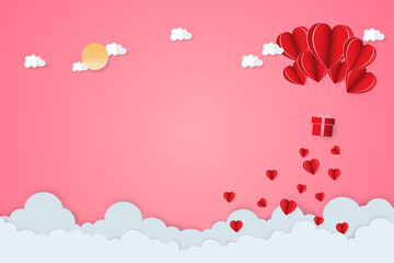 Paper art of Valentine's day festival with heart-shaped paper and cloud shape paper and sun-shaped paper on the pink sky.