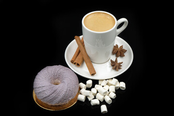 Black coffee in a cup on a black glass background.