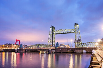 Fototapeta na wymiar Rotterdam, The Netherlands, January 10, 2022: historic steel railway bridge De Hef during the blue hour before sunrise
