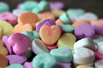 Fototapeta na wymiar Colorful candy hearts with loving messages are a traditional treat on Valentine`s Day.