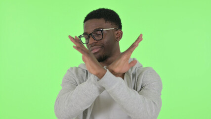 African Man Rejecting by Arm Gesture on Green Background