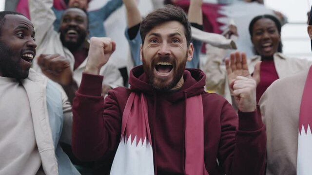 Man emotionally gesturing during goal on soccer game