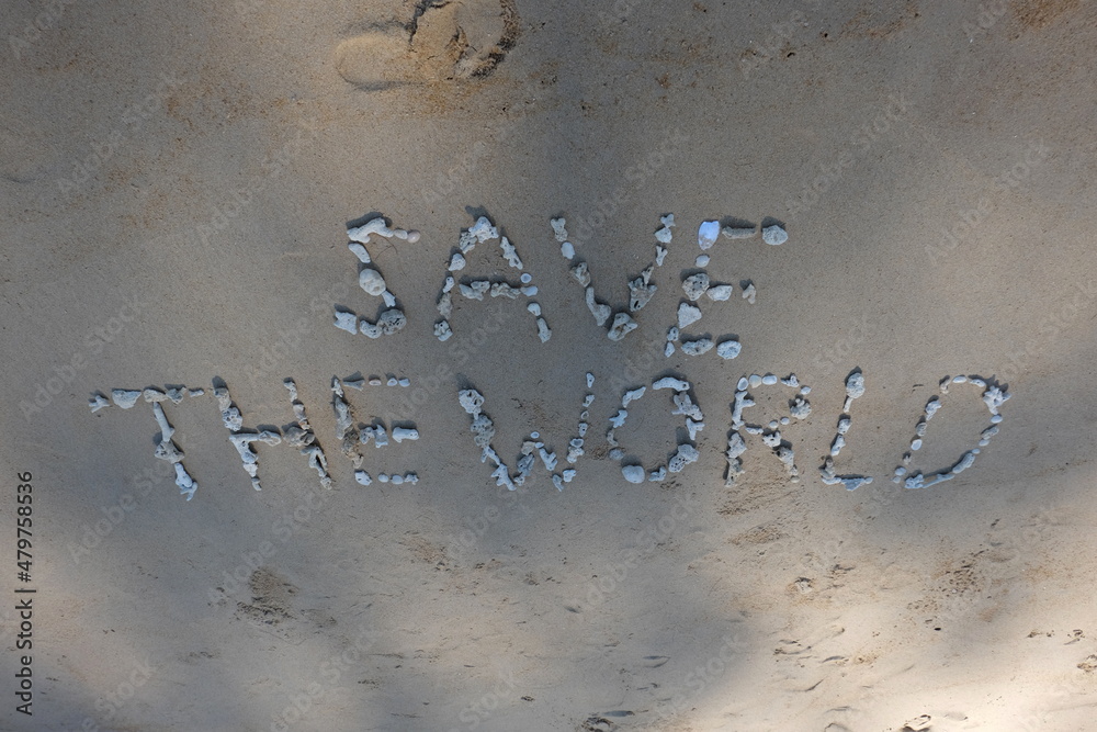 Fototapete the shell is arranged as a message of protecting the world on the sandy beach.