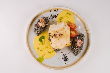 Halibut with black risotto and octopus