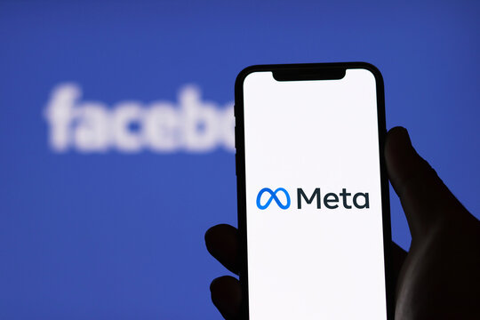 Meta logo on smartphone screen and Facebook logo  background : Chiang Mai, Thailand, January 9, 2022