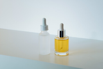 Face serum in matte glass bottle and face oil on white background. Building your skin-care routine regime with peptides and collagen