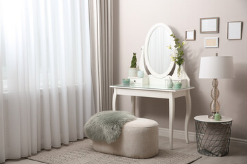 White dressing table with decor near window in room
