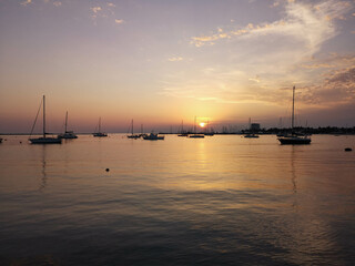 Obraz na płótnie Canvas Sunset at the sea near yacht port