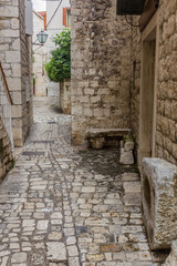 Fototapeta na wymiar Narrow alley in the old town of Trogir, Croatia