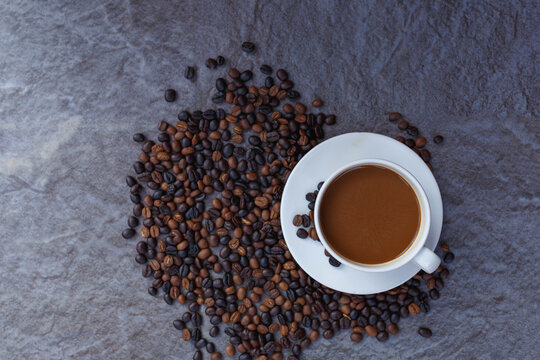 Coffee Cup And Roasted Coffee Beans In Brown Bag, Top View.