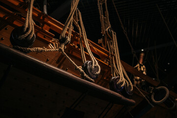 Ropes on a wooden ship, the silhouette of a ship on a black background