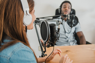 Diverse coworkers recording podcast in studio