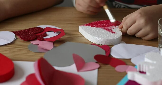 The child draws on foam heart. Creative development of children. Valentines Day 